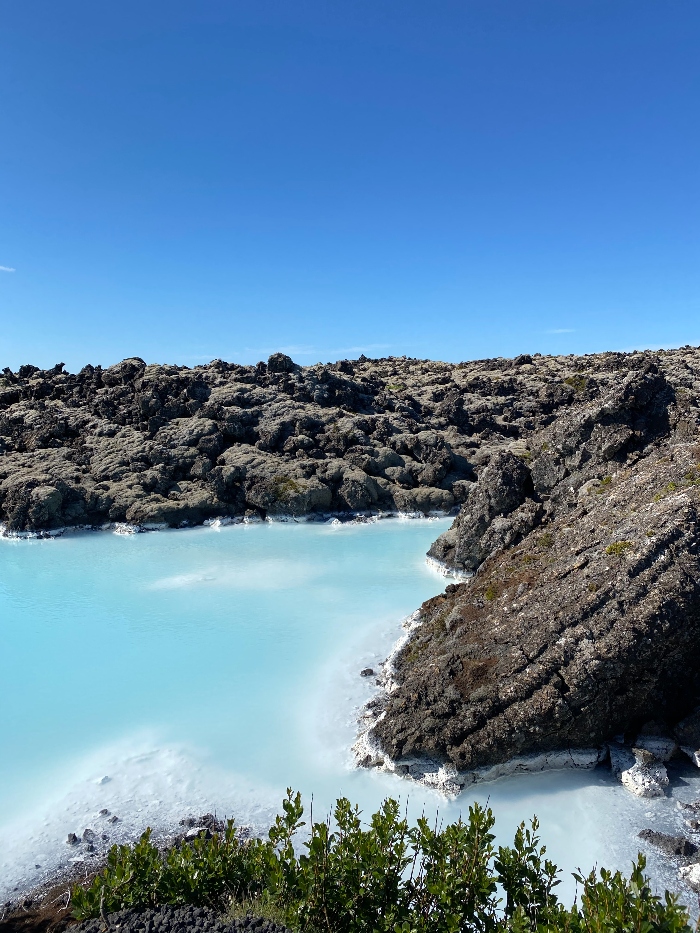 Turish blue water surrounded with lava and blue skies on Reykjanes Peninsula Iceland