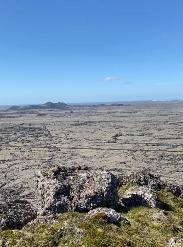 Blue skies and endless moss covered lava fields seen from the top of Mount Thorbjorn in Iceland