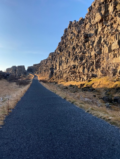 Paved trail in Þingvellir National Park in Iceland with its stunning rock formation walls
