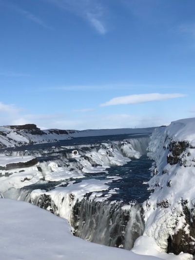 Frozen waterfall in Iceland and blue skies along the Golden Circle route