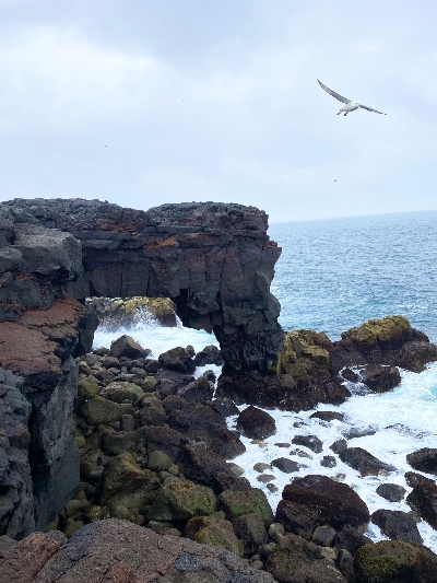 Stone arch in the sea close to Reykjanes Lighthouse