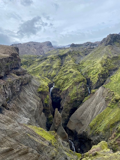 The view over a narrow and deep gorge in Iceland with partly moss covered cliffs