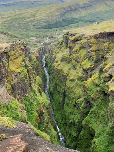 Watching down the narrow, green, moss covered gorge by Glymur Waterfall