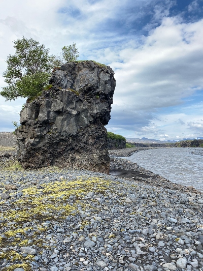 A huge rock standing on the banks of Markárfljót River in Iceland