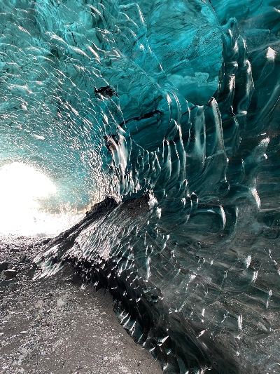 The texture of an black and blue ice cave wall up close