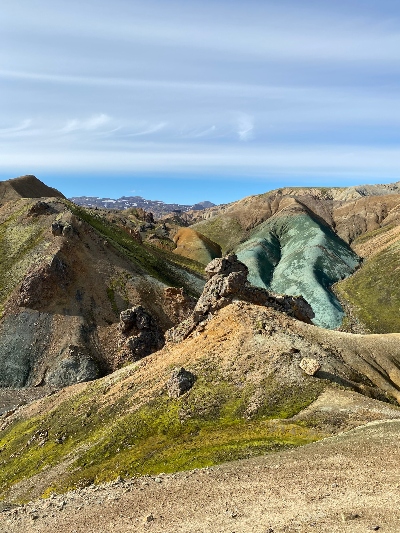 A green ridge sticking out of the otherwise yellow and brownish landscape in Landmannalaugar Iceland