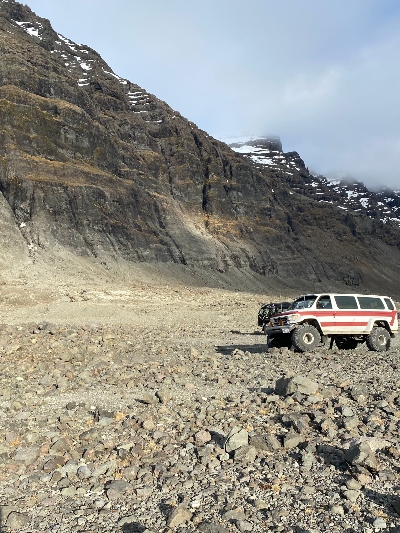 A super jeep parked by the magnificent mountains that mark the beginning of the east fjords in Iceland