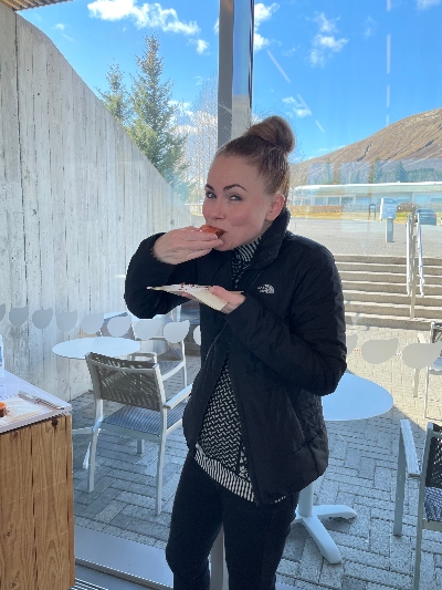 A woman eating some rye bread with smoked salmon at Fontana Geothermal Bakery in Iceland