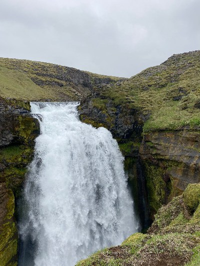 A waterall falling into a very narrow gorge on the Skógafoss Waterfall Hike