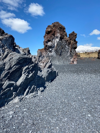 Gray and red lava sculptures on Djúpalónssandur black beach in Iceland