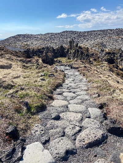A trail made of rocks that leads to a lava field to Djúpalónssandur black beach in Iceland