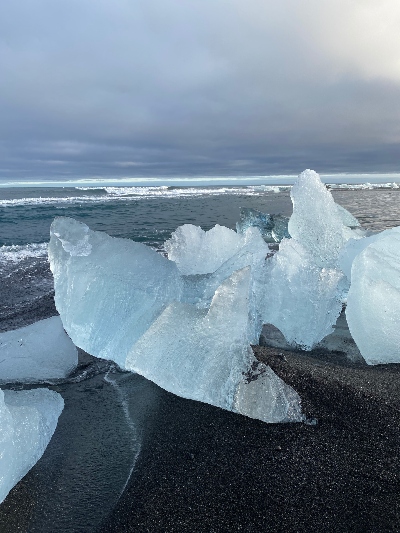 White small icebergs on a black sand beach