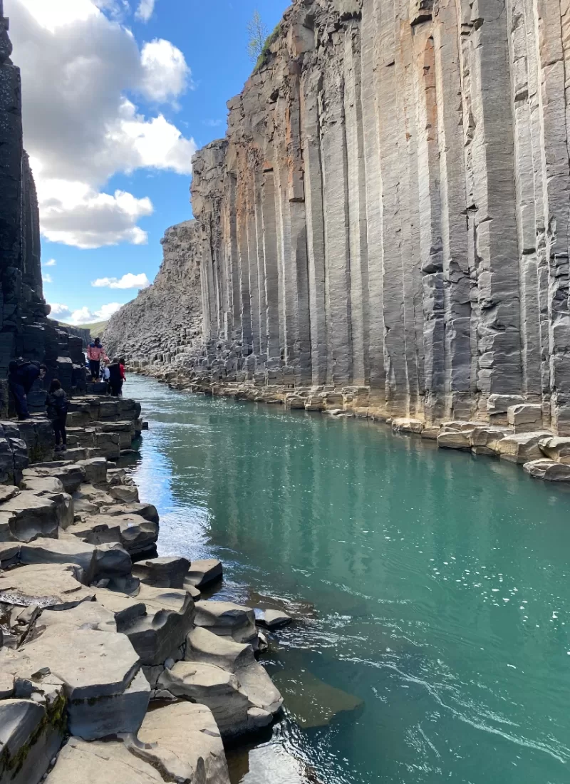 Turquoise water and basalt columns in Stuðlagil Canyon in Iceland