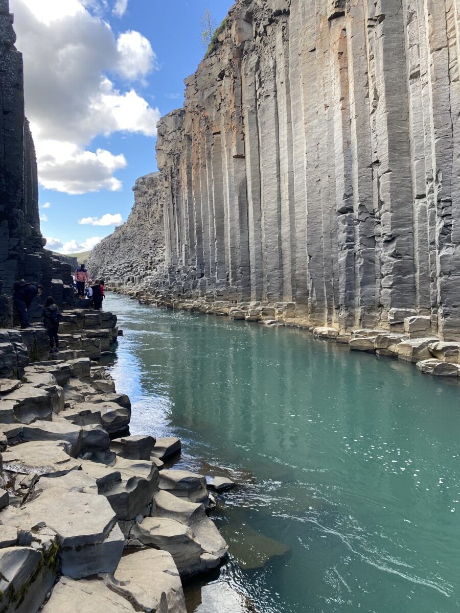 Turquoise water and basalt columns in Stuðlagil Canyon in Iceland