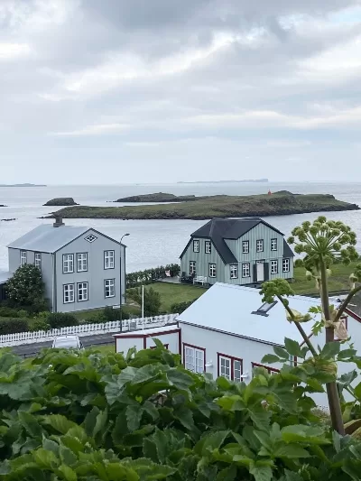 Three old but renovated and charming houses in Stykkishólmur Iceland with the ocean in the back ground