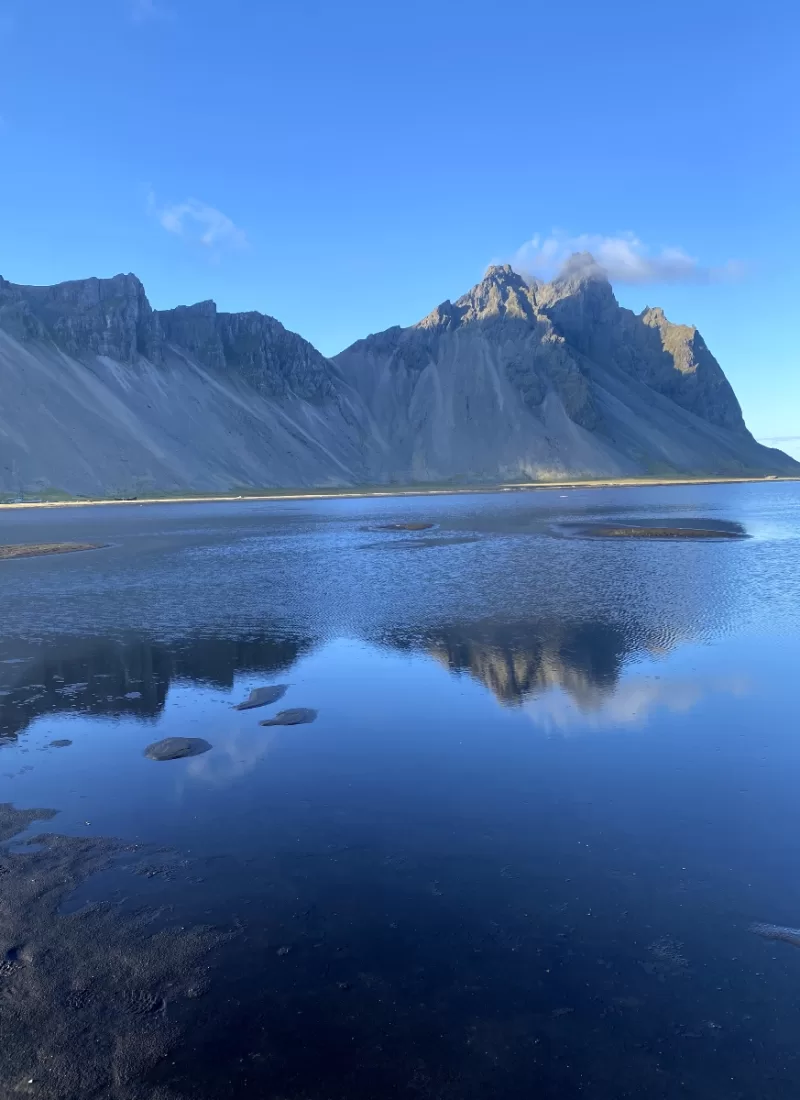 Vestrahorn Mountain and its reflection in the water in front of it