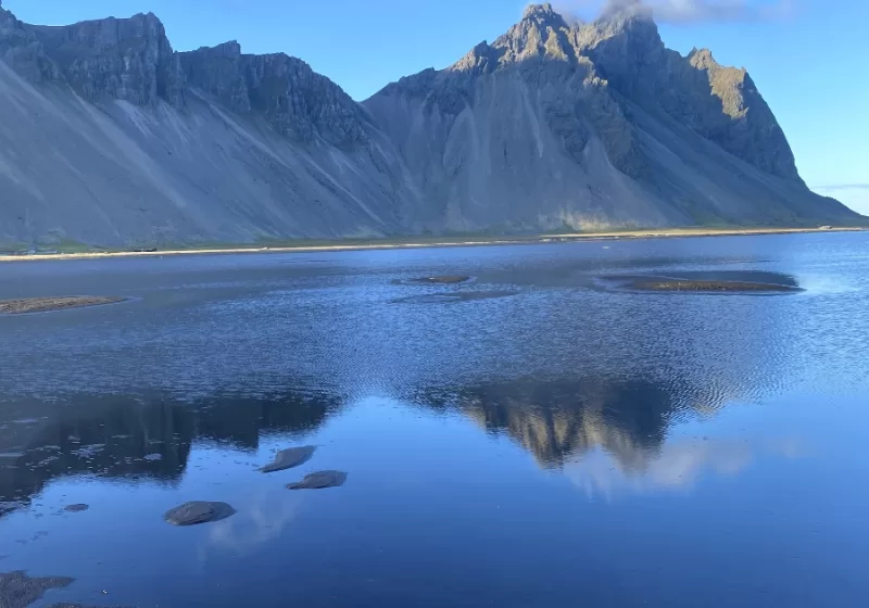 Vestrahorn Mountain and its reflection in the water in front of it