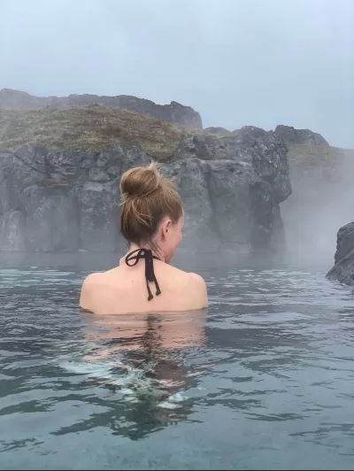 A woman bathing in Sky Lagoon seen from behind