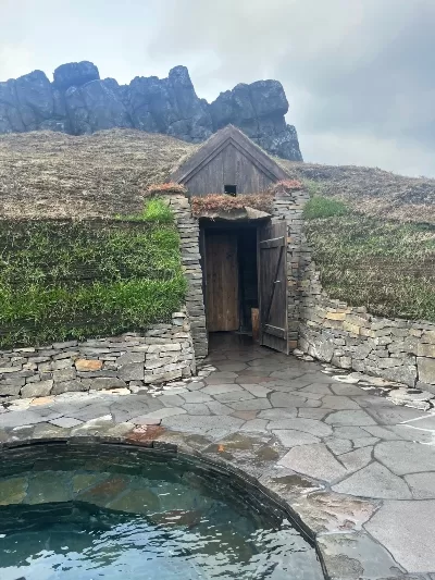 Turf house looking cold plunge and entrance to sauna at the Sky Lagoon Iceland