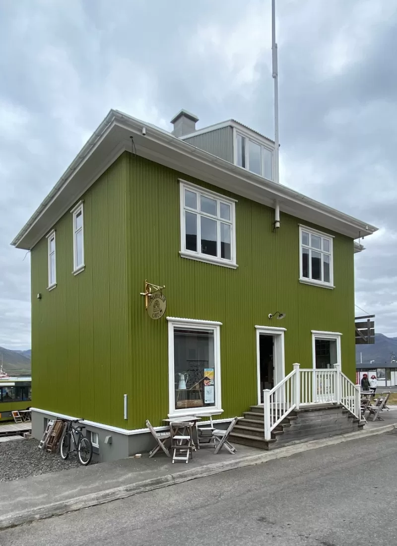 Big green timberhouse called Simbahöllin in Þingeyri that has been renovated.